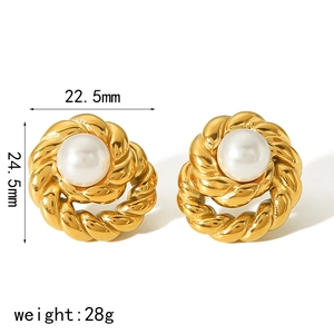 Macro detail of swirl-patterned gold-plated earrings with white pearl inlay 22.5mm