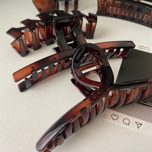 Detail of tortoise shell claw clips in various shapes with premium metal springs