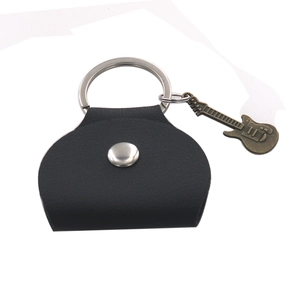 Close-up of black leather guitar pick holder with metal snap and guitar pendant charm