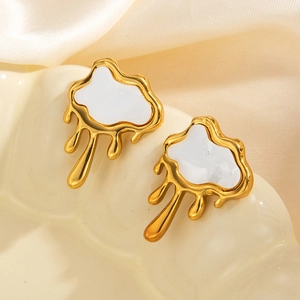 Elegant gold irregular earrings with white cloud enamel on a textured silk background