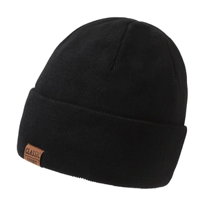 Black ribbed knit beanie with brown leather Classic Sport patch on white background