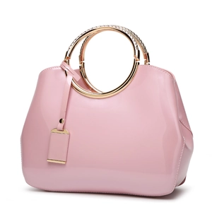 Elegant pink patent leather handbag for women featuring circular gold metal handles
