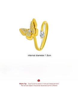 Macro detail of gold-tone butterfly ring showing 1.8cm diameter and 5.1g weight