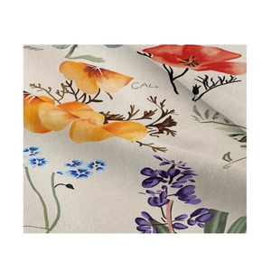 Close-up of watercolor floral tapestry fabric showing texture and vibrant flower patterns