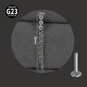 Macro view of G23 titanium labret stud with zircon top and long tassel chain detail
