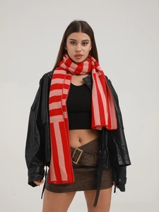 Detail of red and pink striped knit scarf showing soft texture and cozy winter style