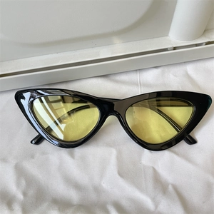 Chic cat-eye sunglasses with black frames and yellow lenses for a retro street style look