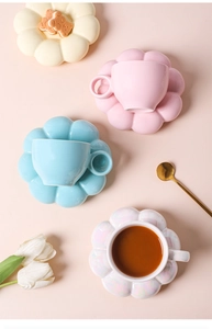 Overhead view of macaron sunflower ceramic coffee cup and saucer sets in assorted colors