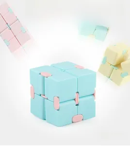 Macro view of macaron blue infinite cube with pink hinges for stress relief