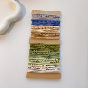 Close-up of assorted colorful high-elasticity braided hair ties on display cards
