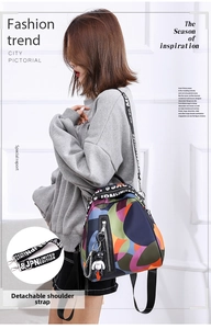 Detail of colorful geometric nylon backpack featuring detachable lettered shoulder strap