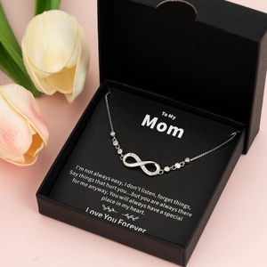 Silver infinity necklace with diamonds in a black gift box with a Mother's Day message