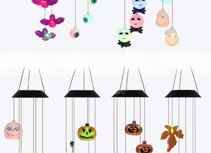 Detail of Halloween solar wind chime featuring glowing bat ghost and pumpkin charms