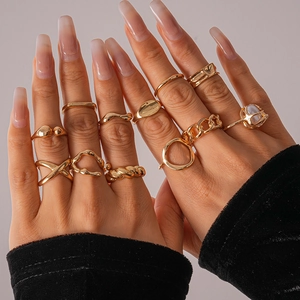 Detail of 11pcs gold geometric rings set styled with mixed layering on hand