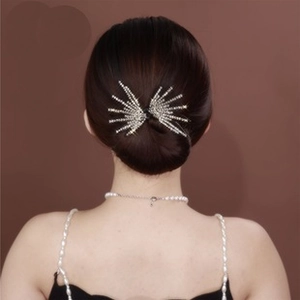 Detailed view of silver sparkling rhinestone hairpin on elegant updo hairstyle for women