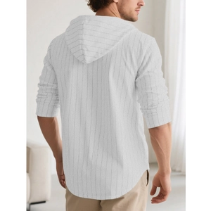 Detail view of a men's striped linen hoodie showing back silhouette and hooded structure