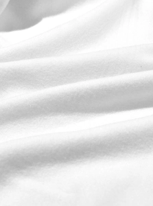 Macro shot of soft white sherpa fleece fabric texture for thick winter hoodie