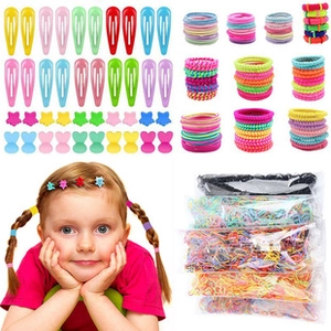 Close-up of colorful metal snap hair clips and elastic hair ties set for girls