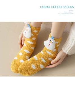 Close-up of fluffy coral fleece Christmas sock with 3D snowman and white polka dots