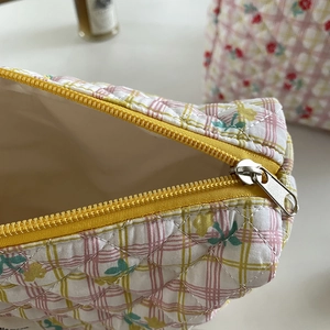 Quilted cotton floral cosmetic bag with large capacity and yellow zipper closure