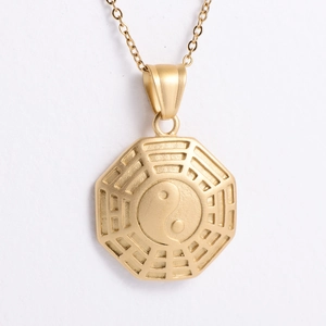 Macro view of matte gold octagonal pendant featuring the Yin Yang Bagua symbol