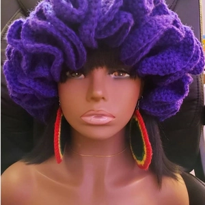 Handmade purple crochet ruffle hat with pleated wave design on a fashion model mannequin