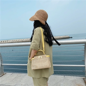 Retro straw woven handbag with yellow leather trim and metal clasp for summer beach style