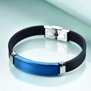 Detail of blue metal plate on black silicone strap with silver stainless steel buckle