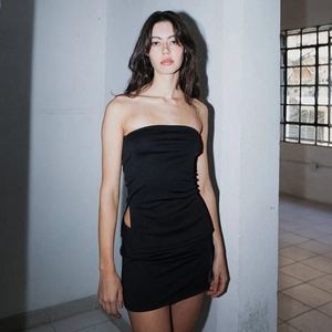 Detail showing the side cut-out design of this black slim fit mini skirt set for women
