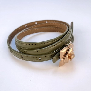 Detail of olive green leather skinny belt with elegant gold rose petal buckle