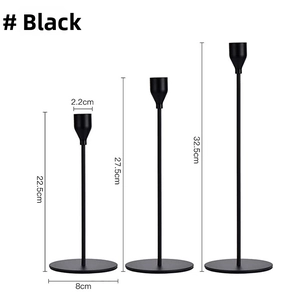 Three matte black metal candle holders in varying heights for minimalist home decor