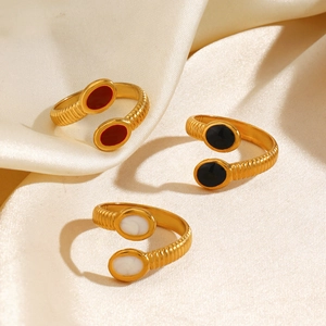 Adjustable gold ribbed rings with oval enamel inlays in red, black and white on silk
