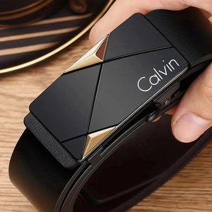 Close-up of black leather belt with black and gold geometric metal automatic buckle