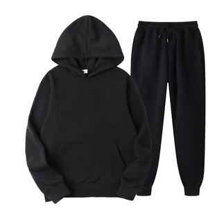 Detail view of black oversized hooded tracksuit with drawstring waist and ribbed cuffs