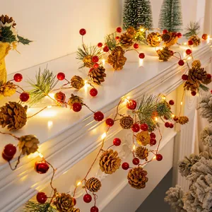 Christmas garland string lights with red berries, pine cones and warm LED glow