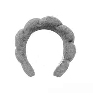 Macro shot of grey sponge padded twisted headband with soft plush fabric texture