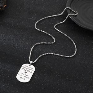 Macro shot of stainless steel dog tag pendant with sentimental Father's Day engraving