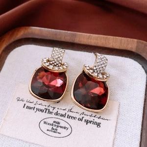 Macro view of vintage gold earrings with red square gemstones and white diamonds