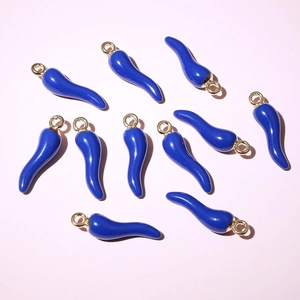 Close-up of dark blue enamel chili pendants with gold loops for DIY jewelry making