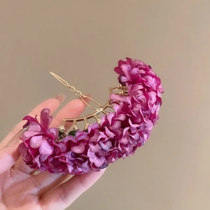 Detailed view of handmade purple fabric flower hair pin with golden metal base