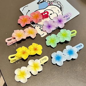 Detail of sweet floral hair clips in seven colors showing resin frangipani flower design