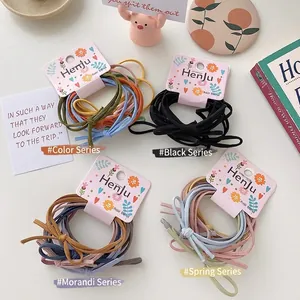 Minimalist elastic hair tie set in Morandi and macaroon colors on a clean white desk