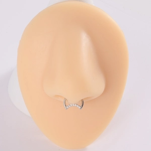 Silver G23 titanium nose ring with sparkling zircons shown on a silicone model nose