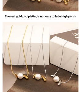 Close-up of high-polish gold and silver snake chains with elegant large pearls