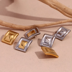 Detail of geometric rectangular stud earrings in gold, silver, and dual-tone finish
