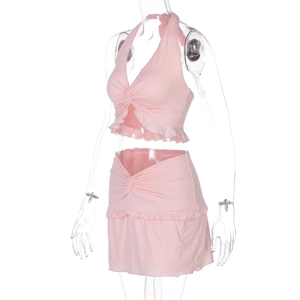 Detail view of pink halter crop top and ruched mini skirt set on a transparent mannequin
