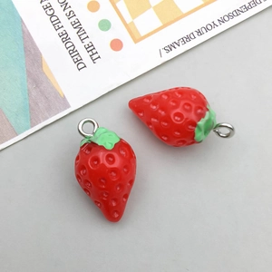 Close-up of a resin strawberry pendant with a silver metal ring for DIY jewelry making