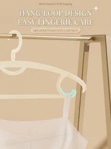 Detail view of non-slip plastic clothes hanger with side hooks for strap garments