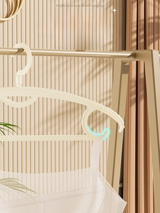Detail view of non-slip plastic clothes hanger with side hooks for strap garments