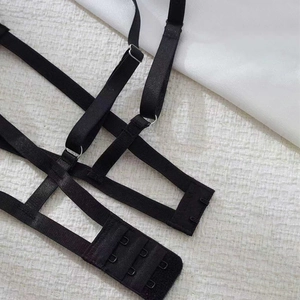 Detailed view of black lace lingerie harness with adjustable straps and multi-row hook closures